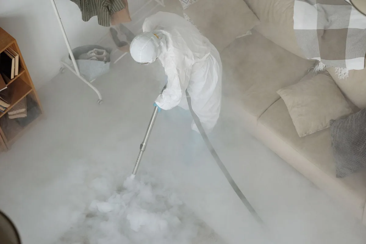 Biohazard cleanup technician in protective equipment, Highlands, TX